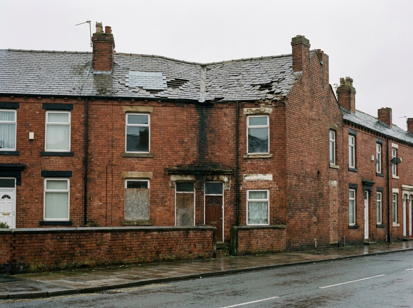 Slipped and missing slates, mismatched patch repairs and a sagging ridge on the terrace roof